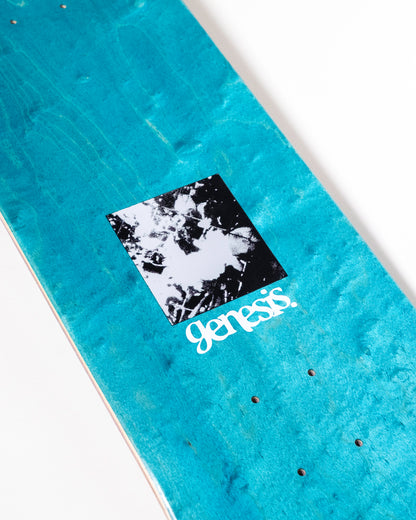 Blue skateboard deck with a black and white graphic and 'genesis' branding on a white background